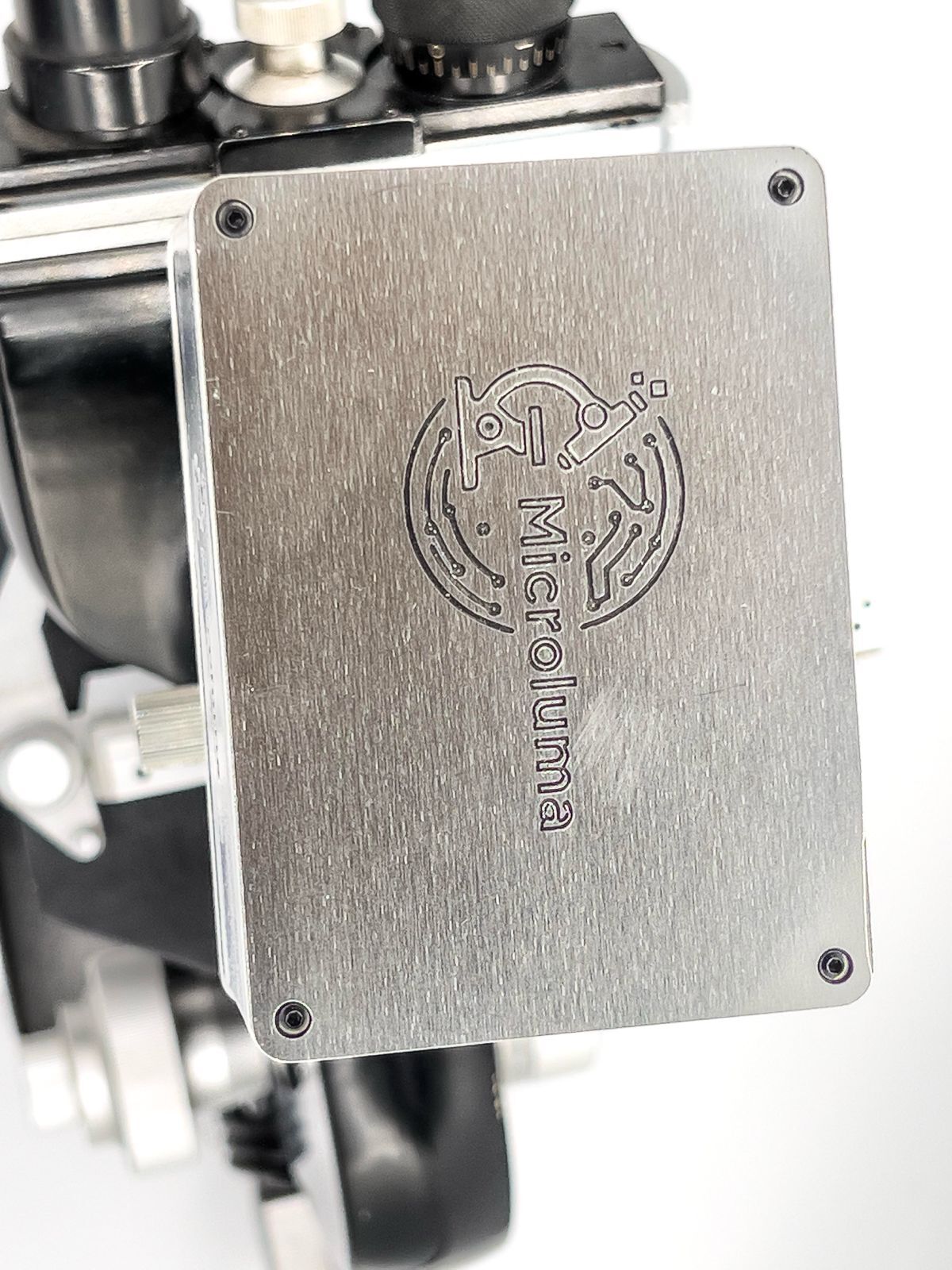 Scientist in a lab coat using a microscope to conduct research, focusing on healthcare improvements.